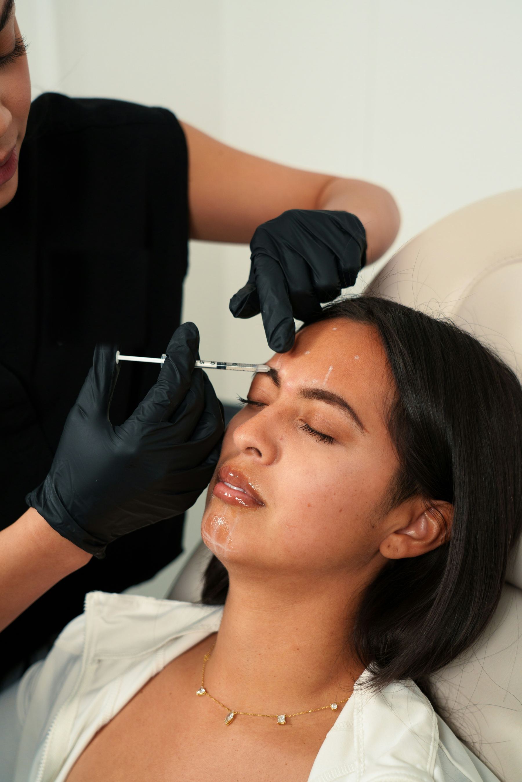 A relaxed patient receiving a brow injection treatment