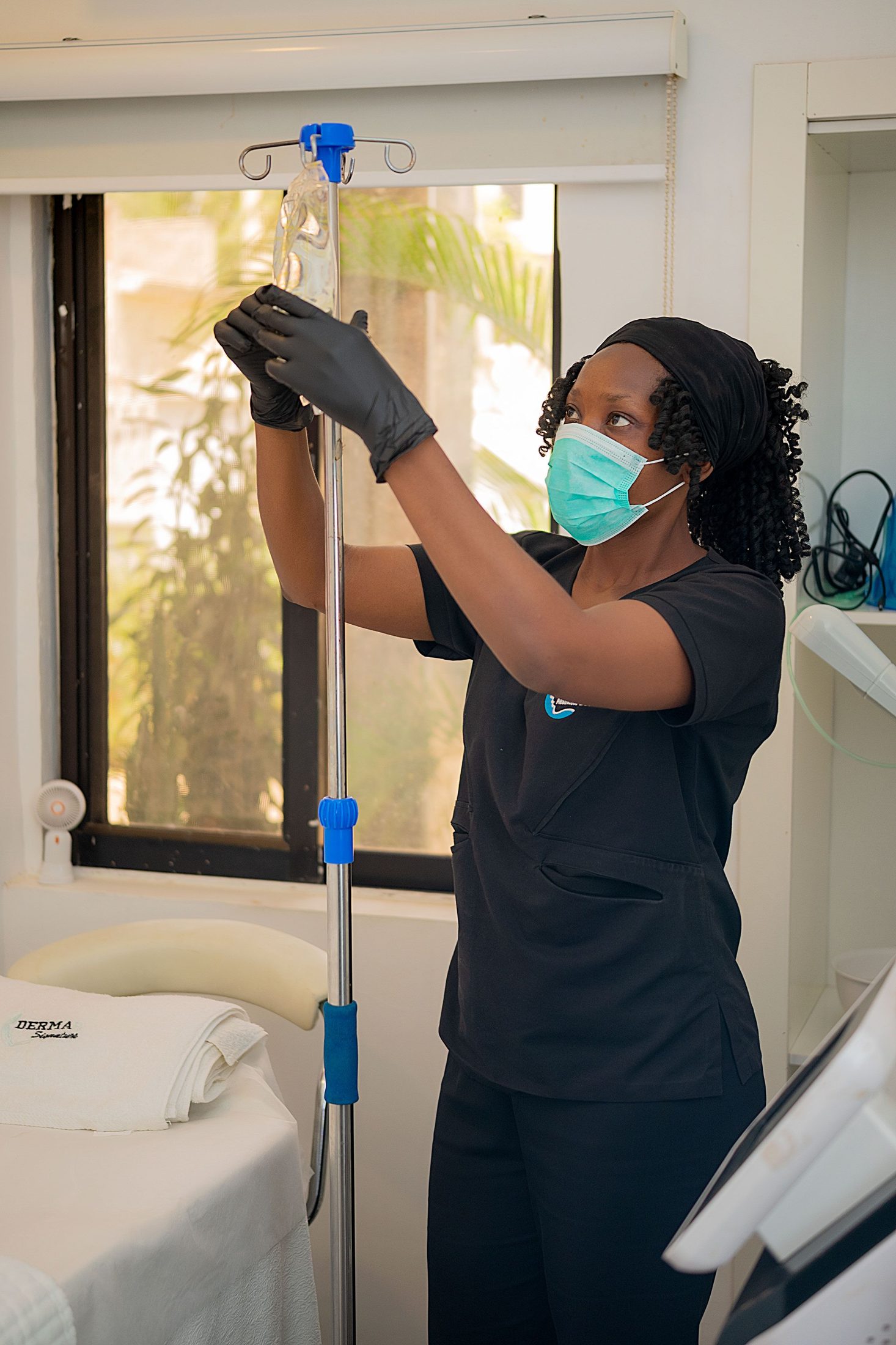 A provider preparing an IV infusion for a patient in a treatment room