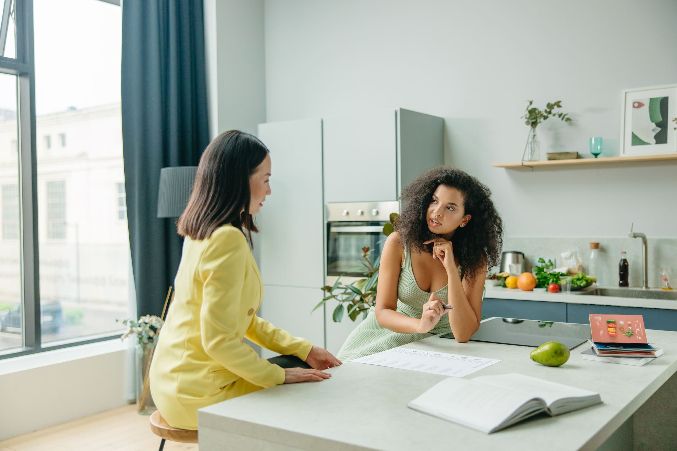 A nutrition coach reviewing a plan with a patient in a kitchen
