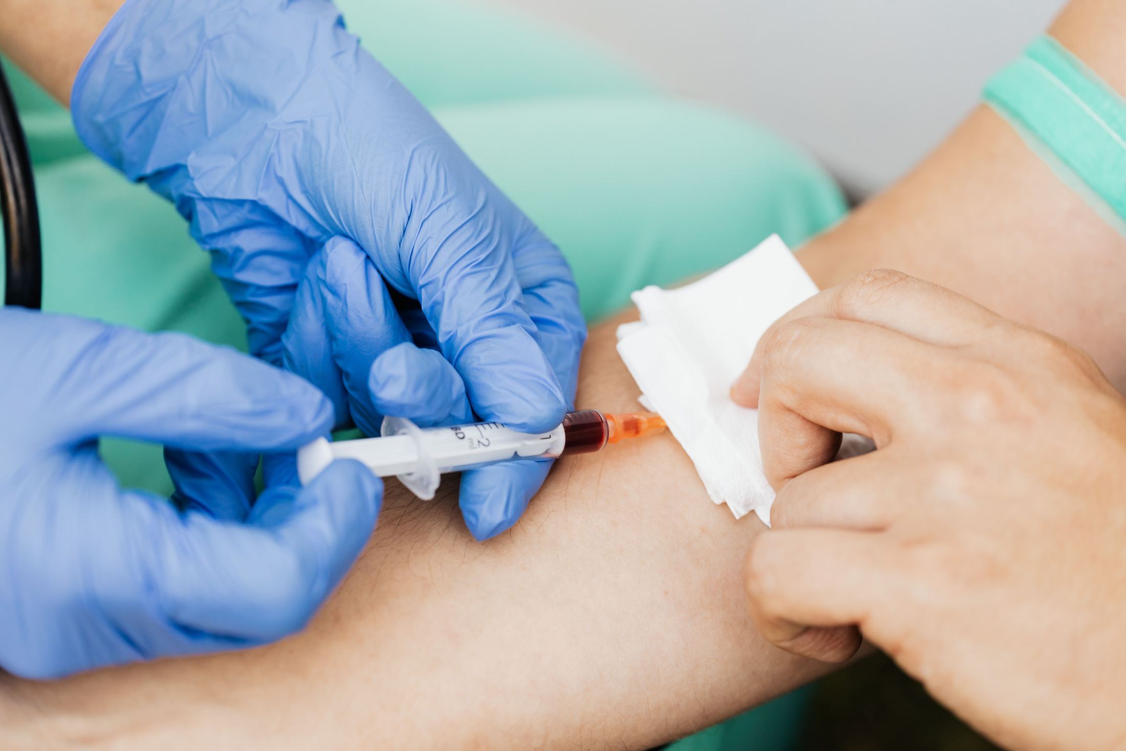 A provider drawing blood for PRP preparation
